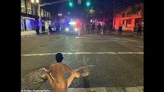 Naked Athena' strips off dares police to shoot tear gas during stand-off in 'Battle of Portland'