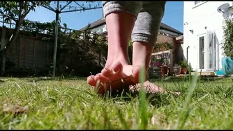 Sexy Mistress feet ripping grass in the garden by feet of a mistress